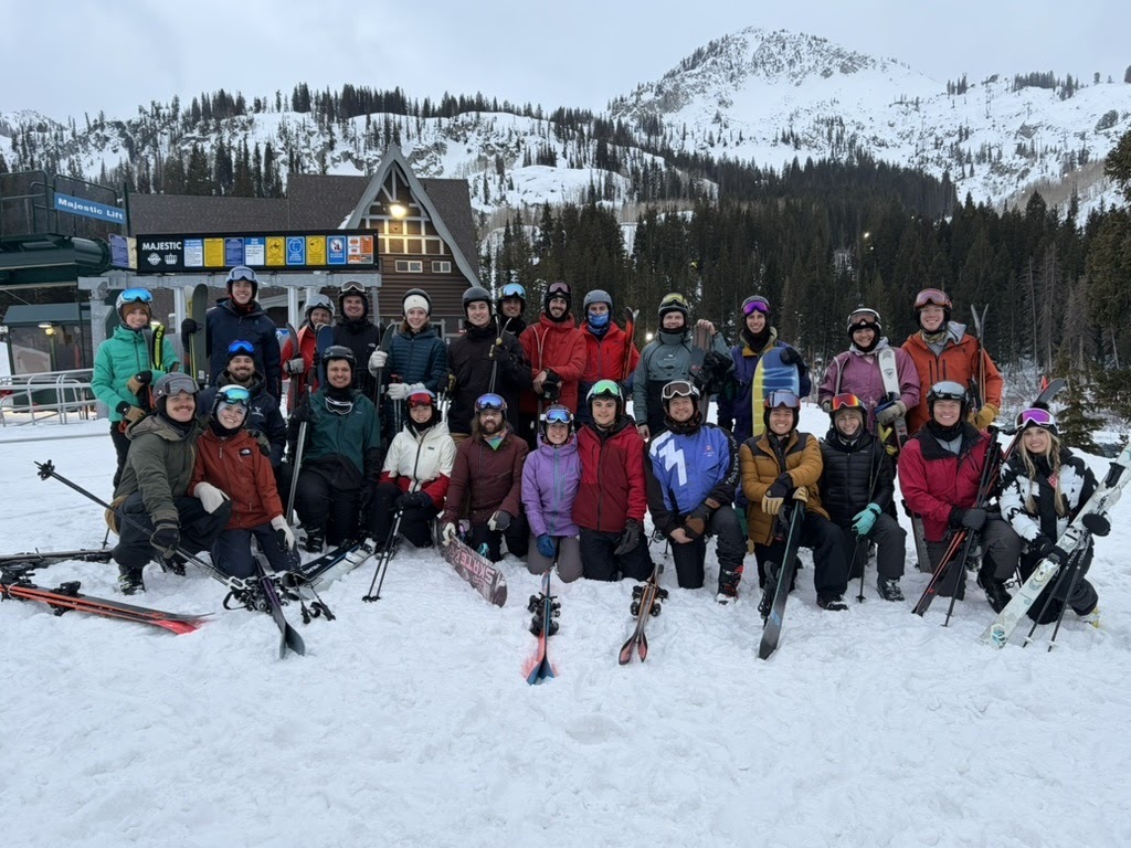 Leland team outdoors with mountain lake backdrop